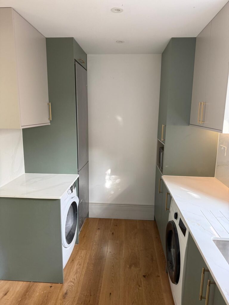 Fitted utility room with sage green cabinetry and quartz worktops by R3 Carpentry, West London
