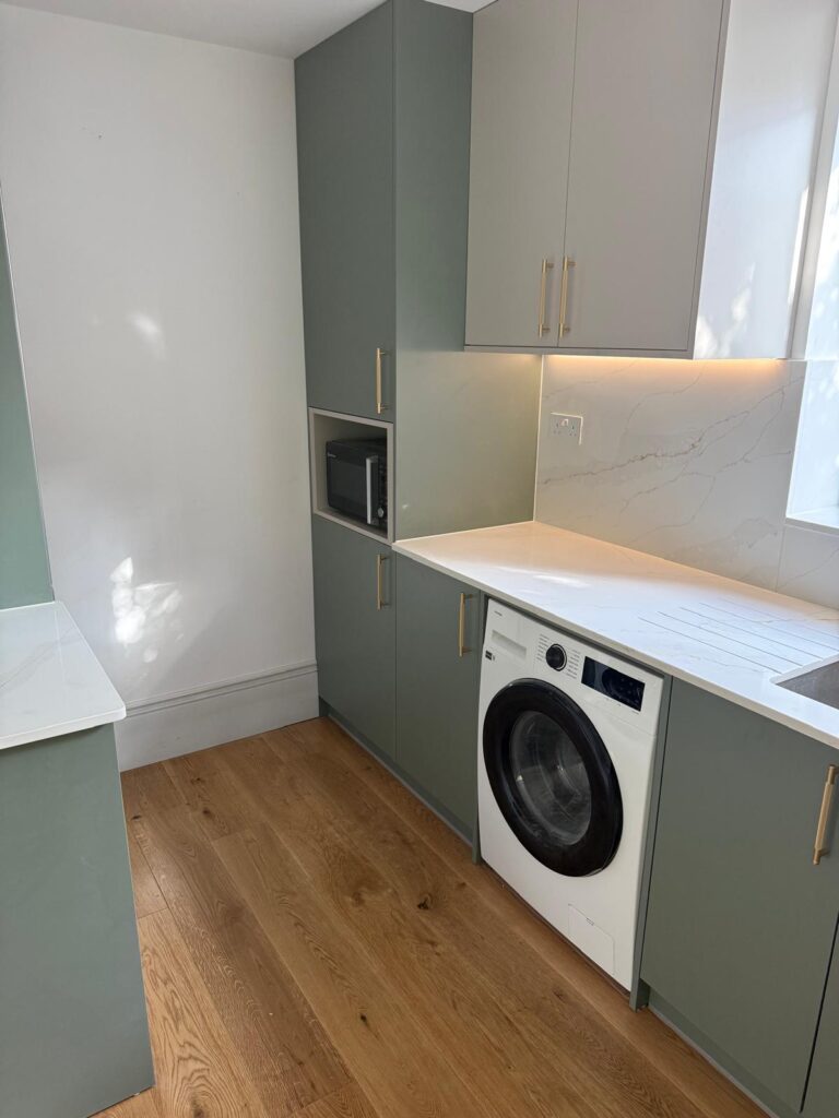 Fitted utility room with built-in storage and sage green cabinets by R3 Carpentry, Acton