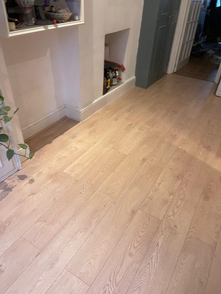 Light oak wood flooring fitted through a hallway